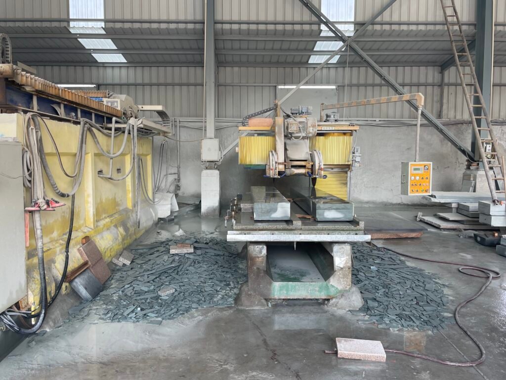 Professional stone carving workshop at Huafa Stone with heavy-duty cutting machinery for custom architectural stone projects.