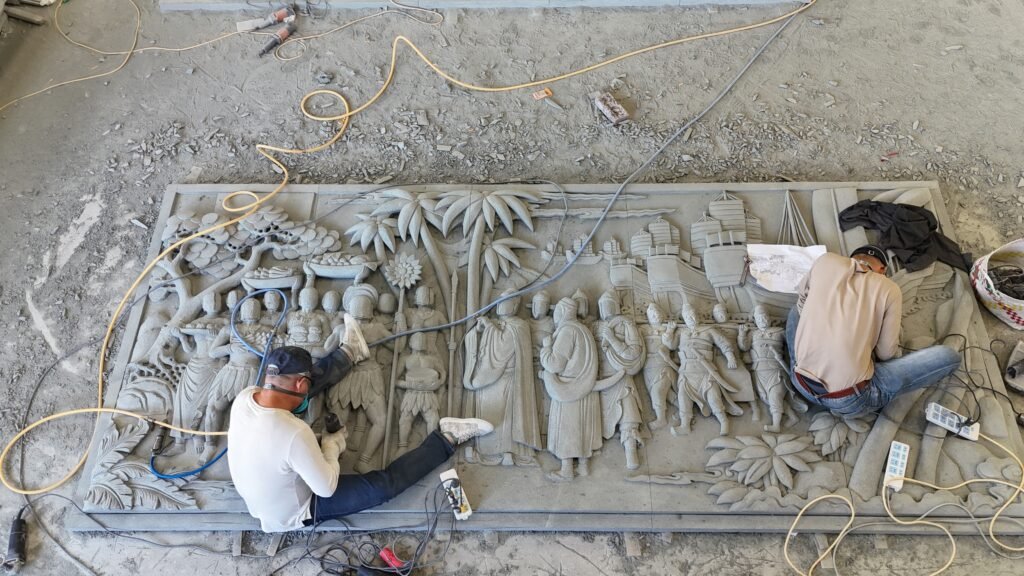 Artisans at work on detailed Zheng He custom stone sculptures.